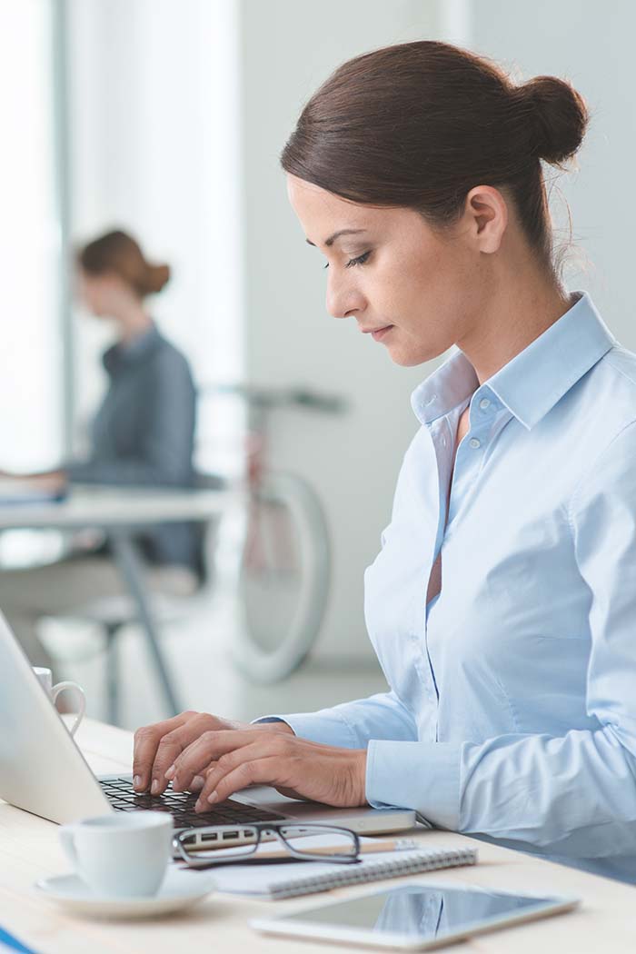 woman-working-on-laptop-at-desk-in-office