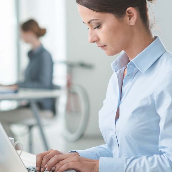 woman-working-on-laptop-at-desk-in-office